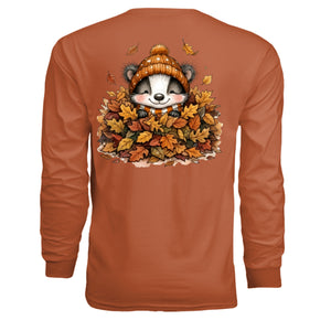 fall graphic long sleeve tee featuring a playful badger in a pile of autumn leaves.