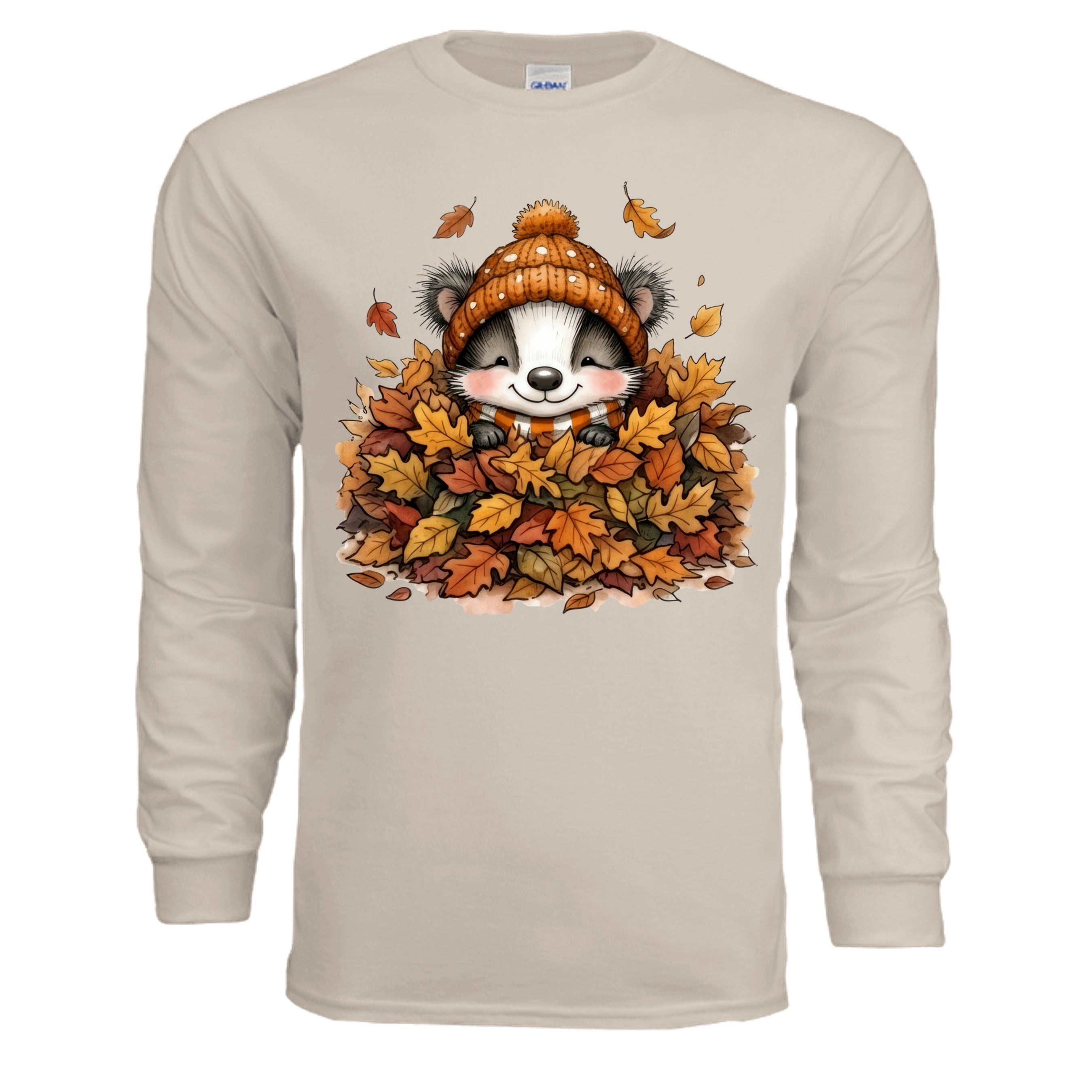 Leaf Pile Badger Long Sleeve Tee in sand color featuring a whimsical badger graphic surrounded by autumn leaves.